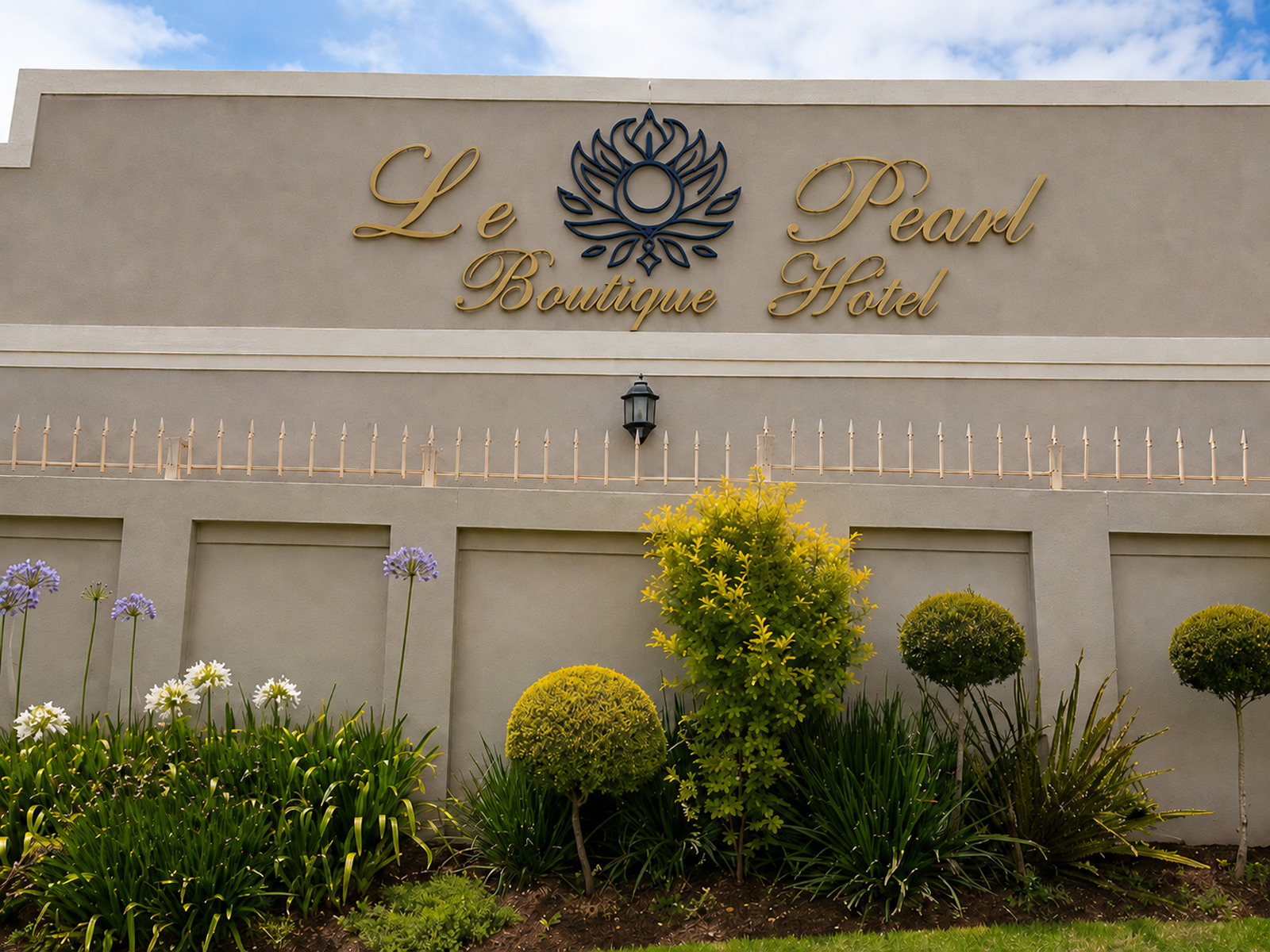 Le Pearl Boutique Hotel exterior signage and landscaped garden